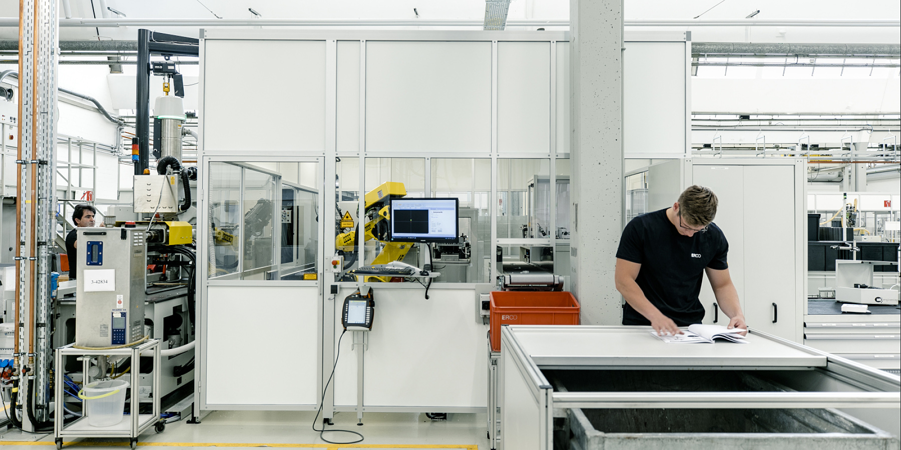 ERCO employee in production reviewing documents, highlighting focus on quality and precision in daily work.