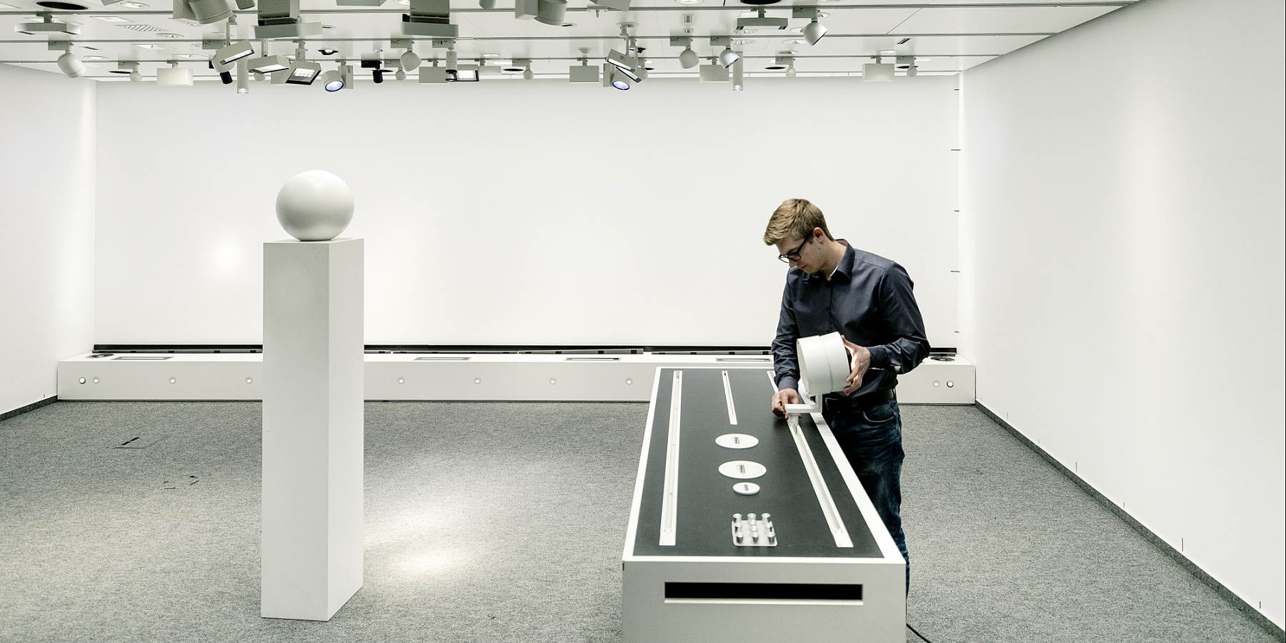 ERCO employee adjusts lighting in a showroom in Lüdenscheid, Germany.