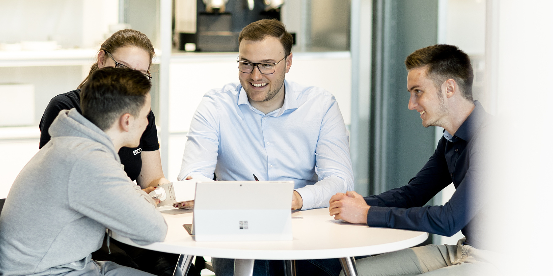 ERCO team collaborating on lighting solutions in the office.