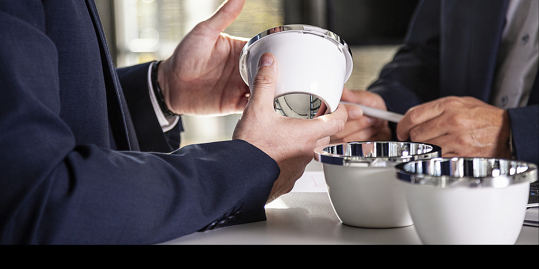 ERCO lighting tool components in hand, part of a successful collaboration.