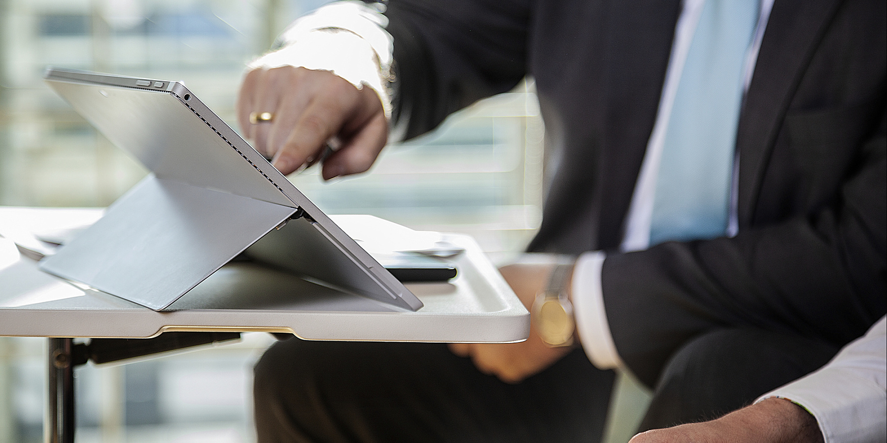 A man working on a tablet, highlighting modern tech and efficient collaboration.