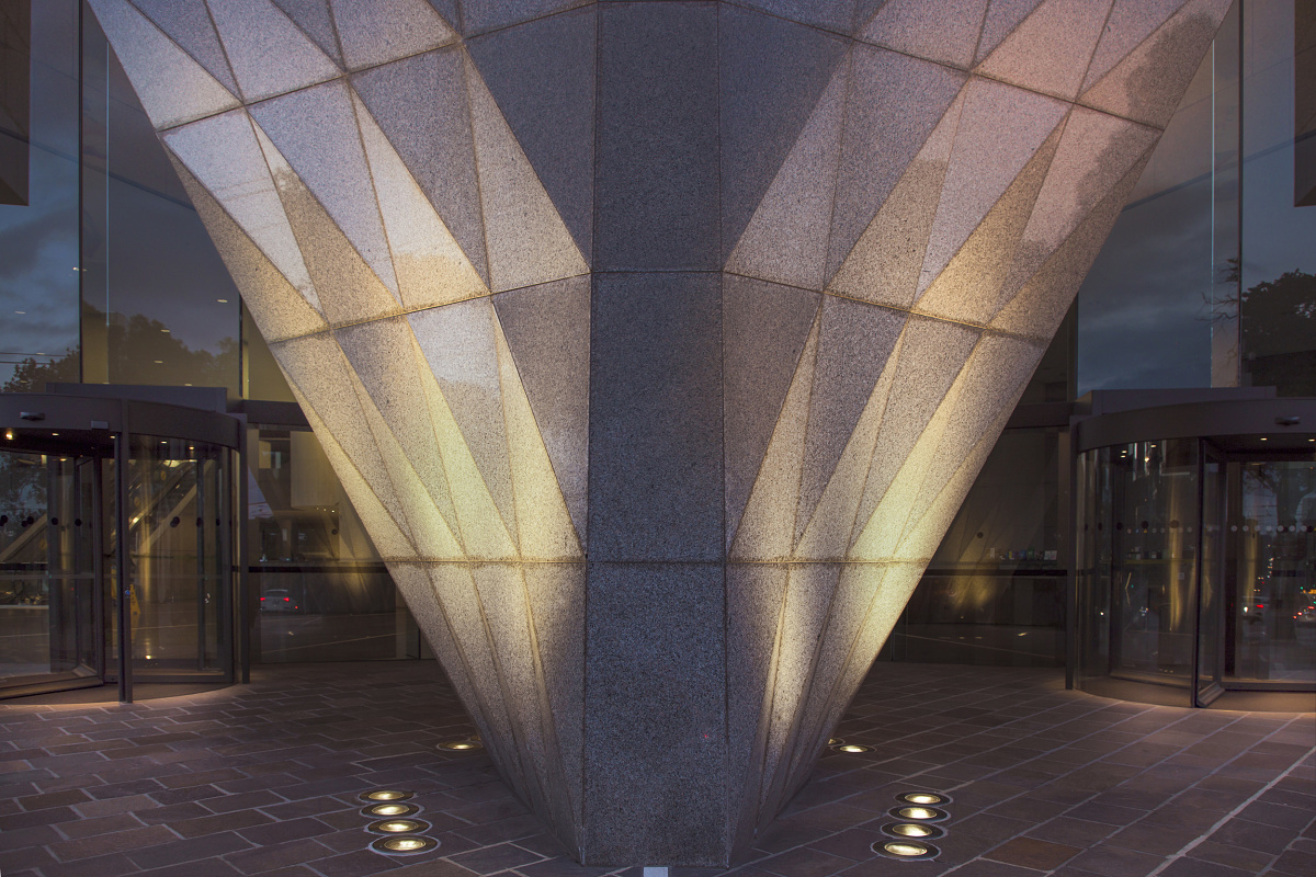 Illuminated facade of 1 Spring Street building in Melbourne with ERCO in-ground luminaires.