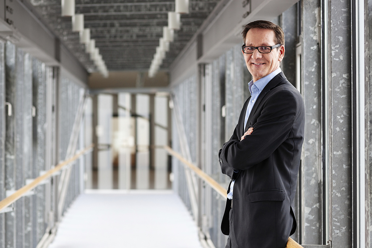 ERCO Purchasing Manager, standing confidently in a modern office environment.
