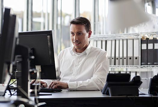 ERCO employee working on a computer in the office.