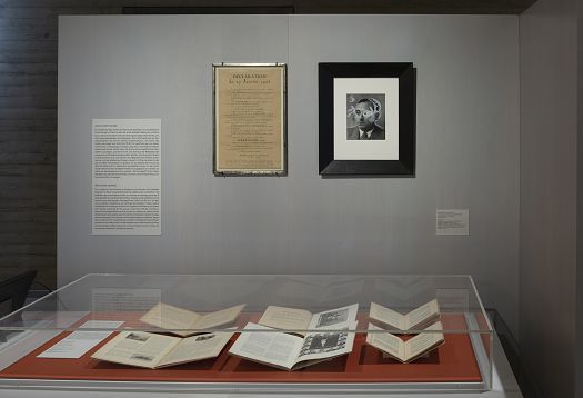 Exhibition view in Blockhaus Dresden featuring documents and portrait under ERCO LED lighting.
