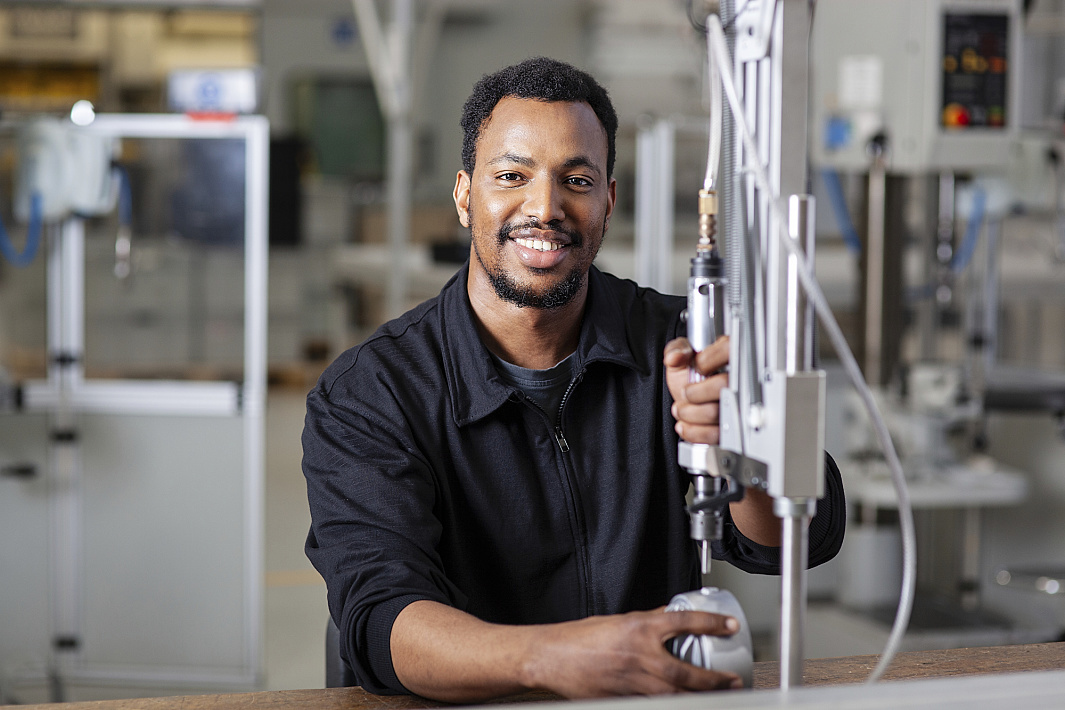 ERCO employee assembling lighting components in a production environment.