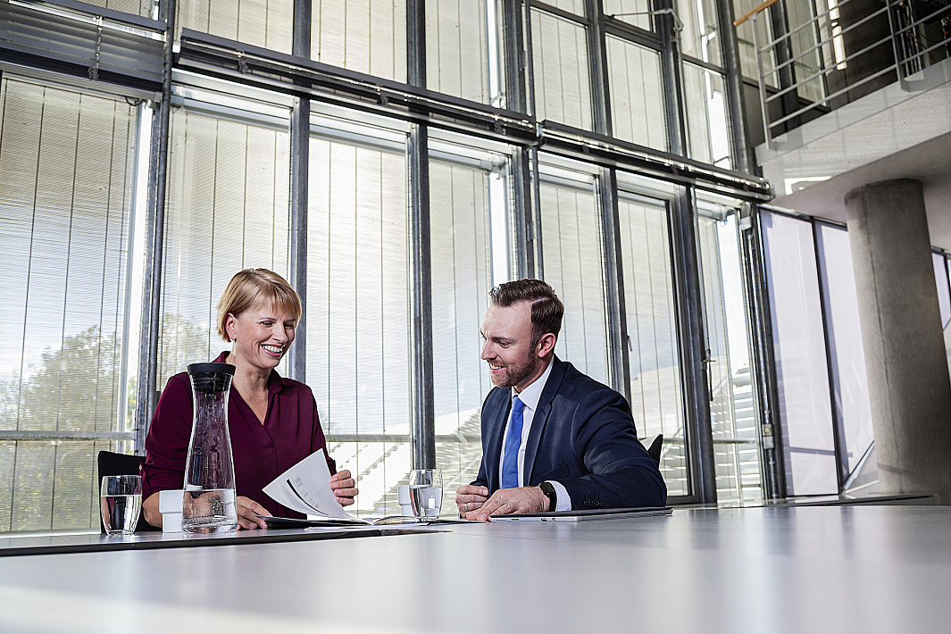 ERCO partners discussing lighting plans in a modern office.