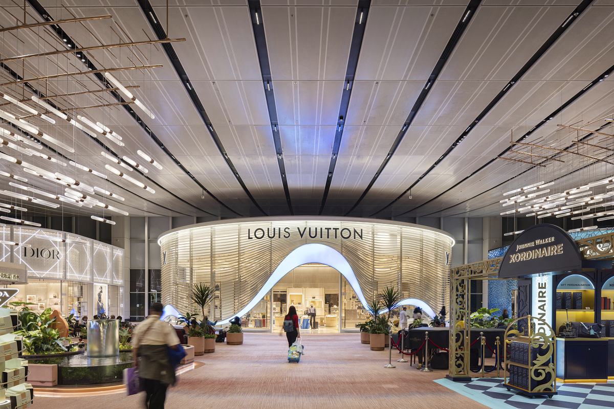 Changi Airport Terminal 2 featuring ERCO LED downlights and a Louis Vuitton store.