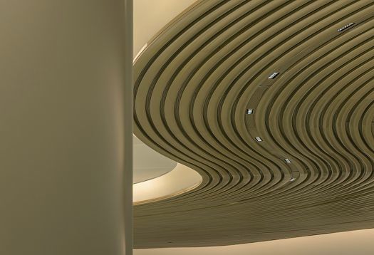 Curved ceiling structure with ERCO LED downlights at Changi Airport, Singapore.