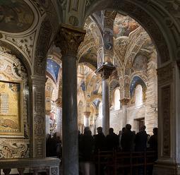 Church interior featuring indirect lighting and accent lights on religious artifacts.