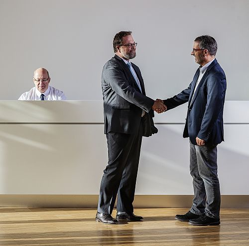 ERCO partners shake hands, symbolizing CSR and a successful collaboration.