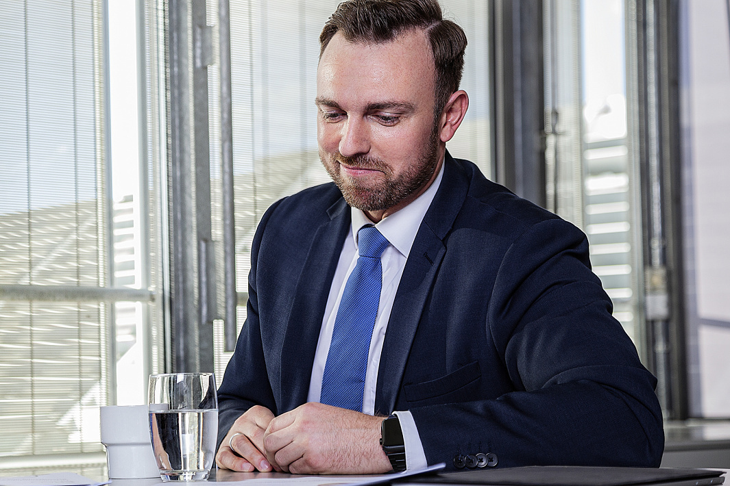 Businessman at desk, focusing on ethical responsibility in ERCO purchasing.