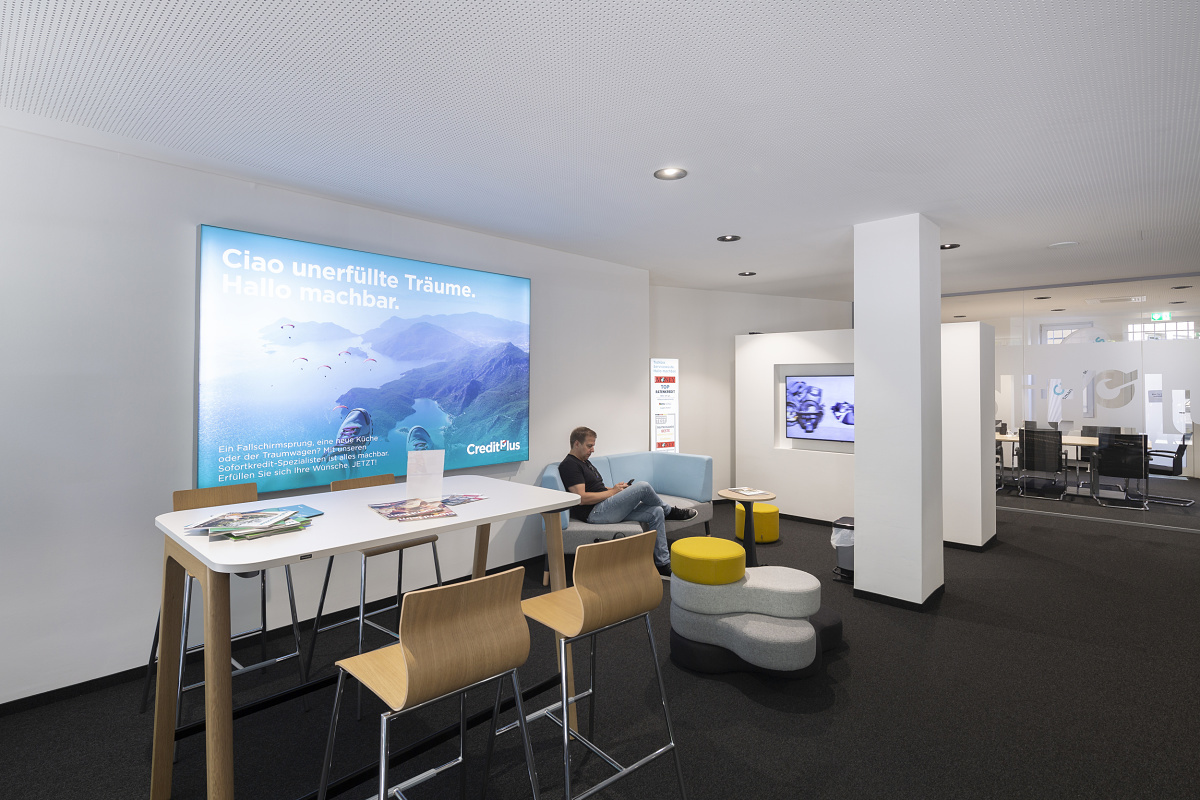 Creditplus Bank AG Berlin waiting area featuring ERCO Skim downlights for ambient lighting.