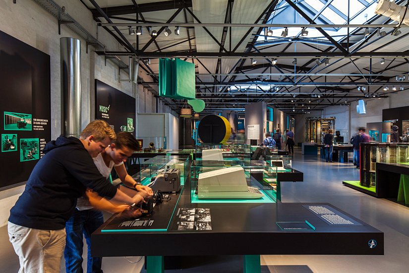 Visitors at the German Museum of Technology in Berlin, lit by ERCO LED lighting.