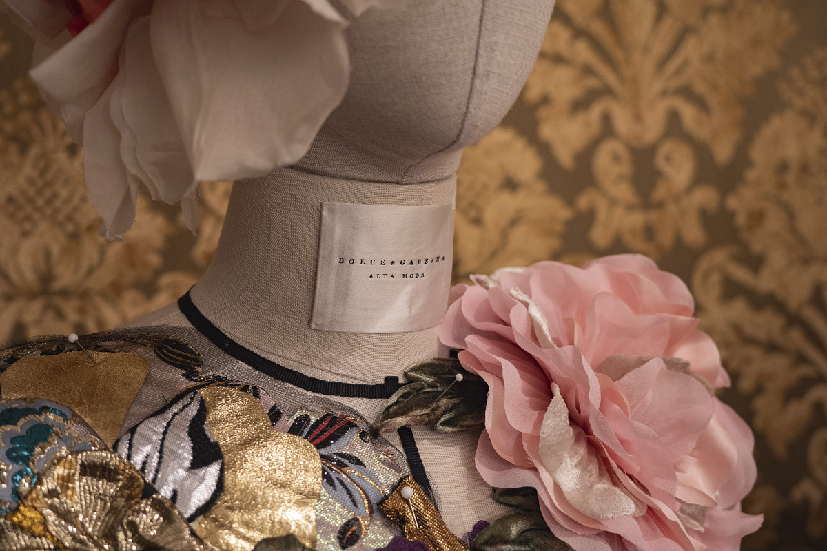 Dolce & Gabbana Alta Moda dress on a mannequin, part of Milan exhibition.