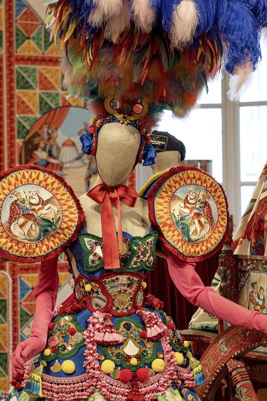 Dolce & Gabbana fashion exhibit: Intricate, colorful craftsmanship on a mannequin, illuminated by ERCO lighting.