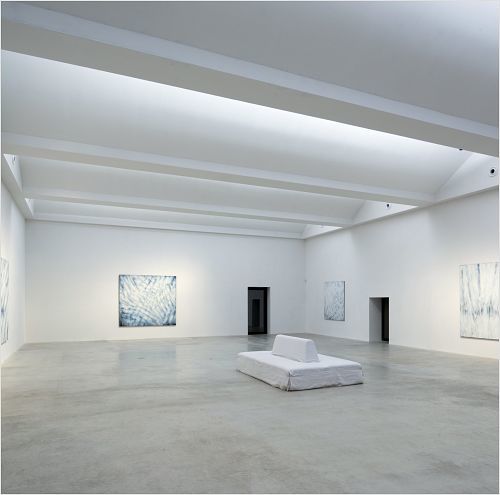 Gallery interior featuring art and ERCO LED lighting, promoting energy-efficient exhibitions.