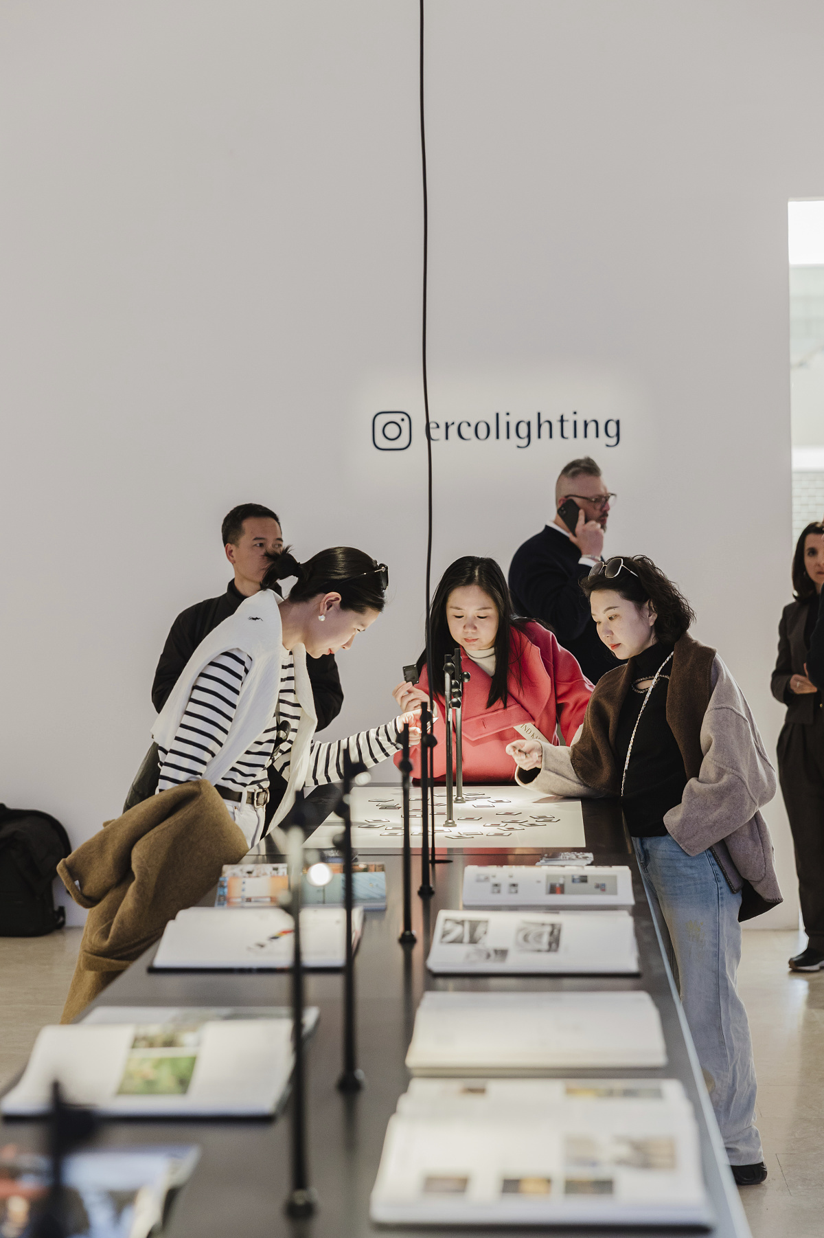 Visitors view ERCO lighting solutions at the ERCO Light Box exhibition in Milan.