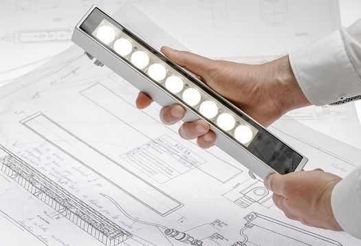 ERCO lighting design: LED luminaire illuminating architectural blueprints for architects.