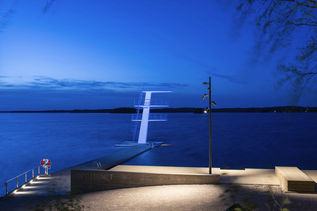 Evedal swimming pool, Växjö, illuminated with LED lighting for diving platforms and walkways at night.