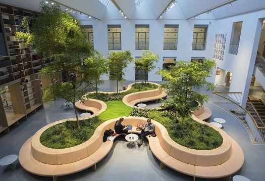 Interior with green wall lighting and seating, promoting well-being and better indoor climate.