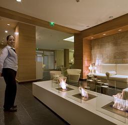 Hotel lobby featuring atmospheric lighting and a fireplace for an inviting ambiance.