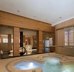 Hotel wellness area featuring ERCO lighting: A relaxing space with pools and soft light.
