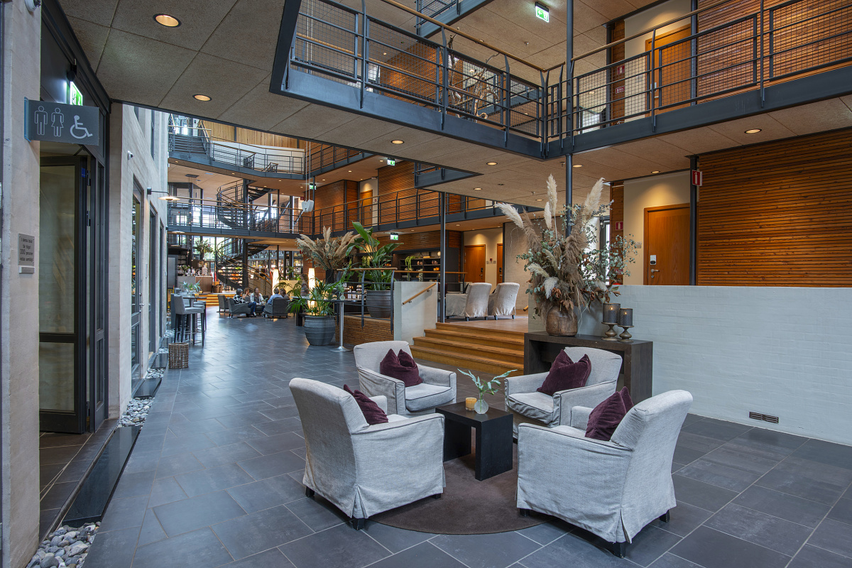 Hotel Skansen lobby featuring ERCO Iku recessed lights for glare-free ambient lighting.