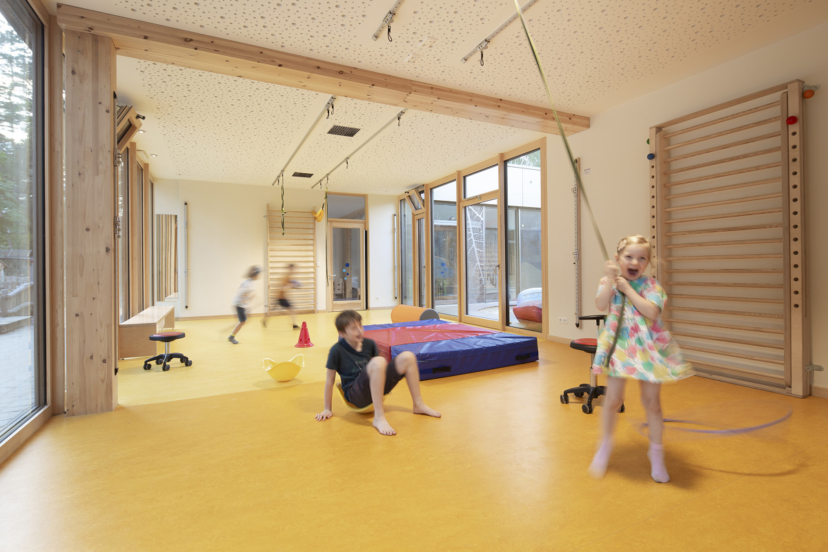 Children play in Rappelkiste Day Care Centre, Berlin, with ERCO LED lighting for visual comfort.