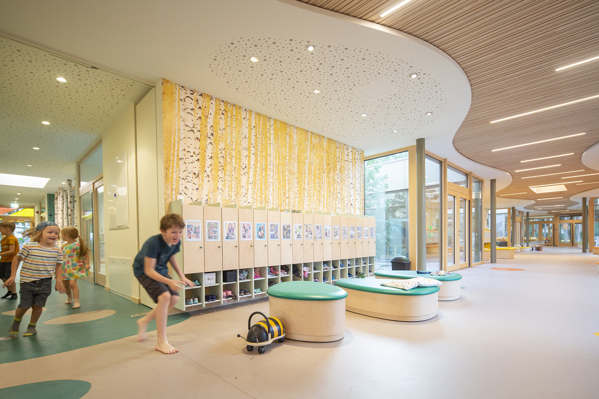 Children playing in Rappelkiste Day Care Centre, illuminated by ERCO LED lighting for visual comfort.
