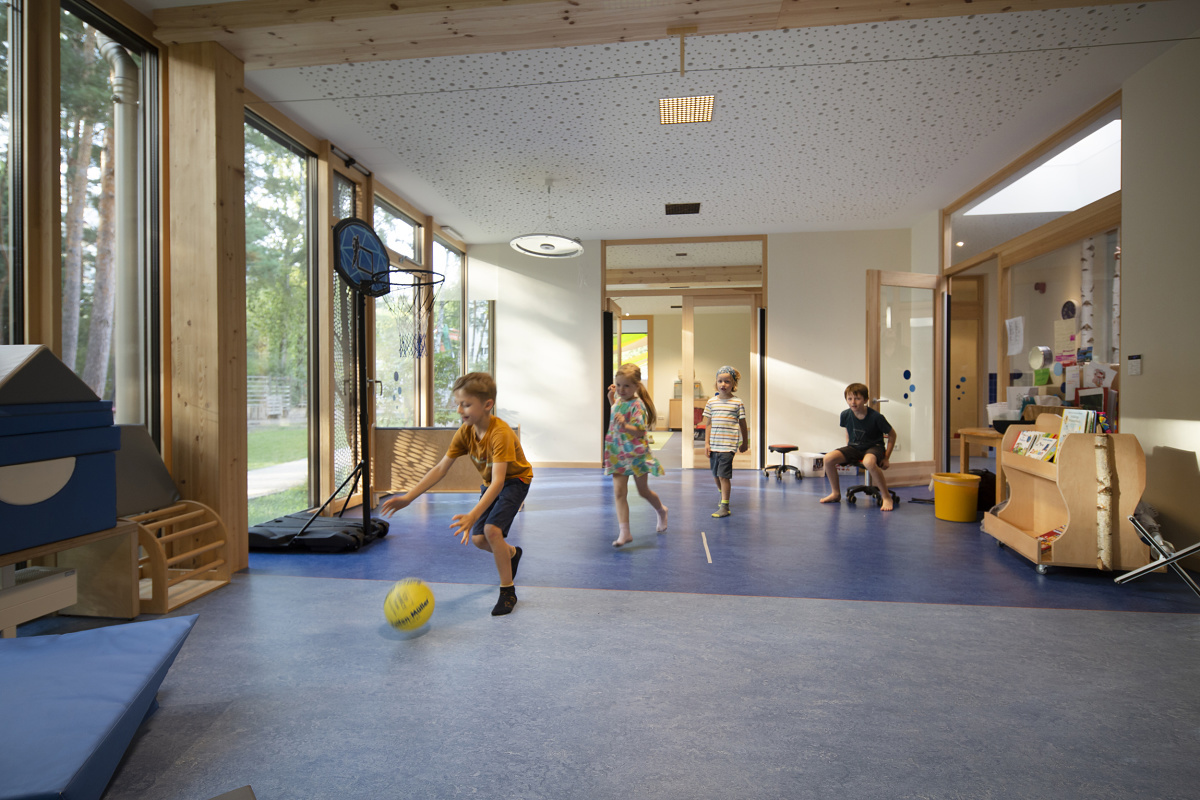 Children playing under ERCO LED lighting at Rappelkiste Day Care, Berlin.