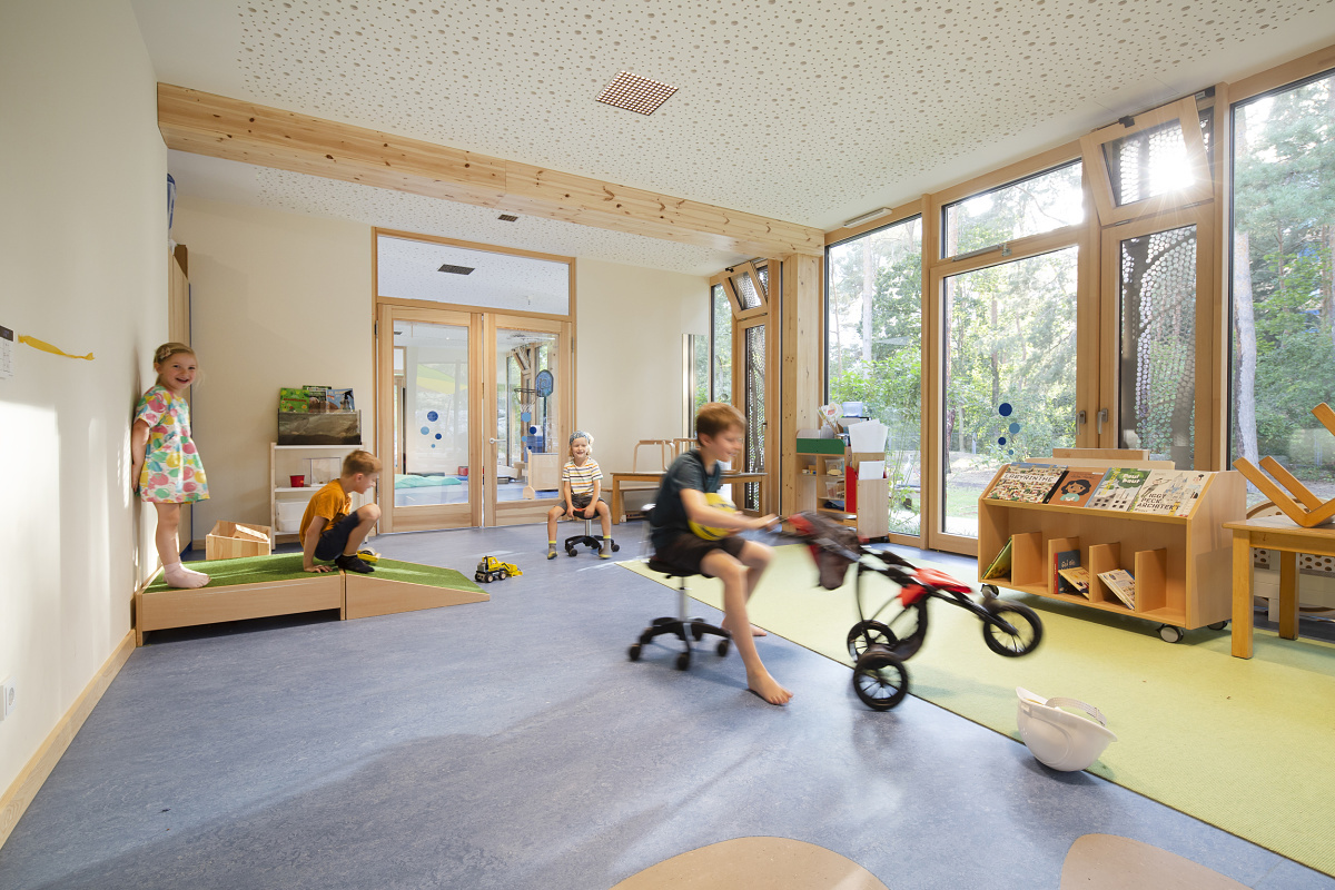 Bright LED lighting at Rappelkiste Day Care, Berlin, with children playing in a friendly environment.