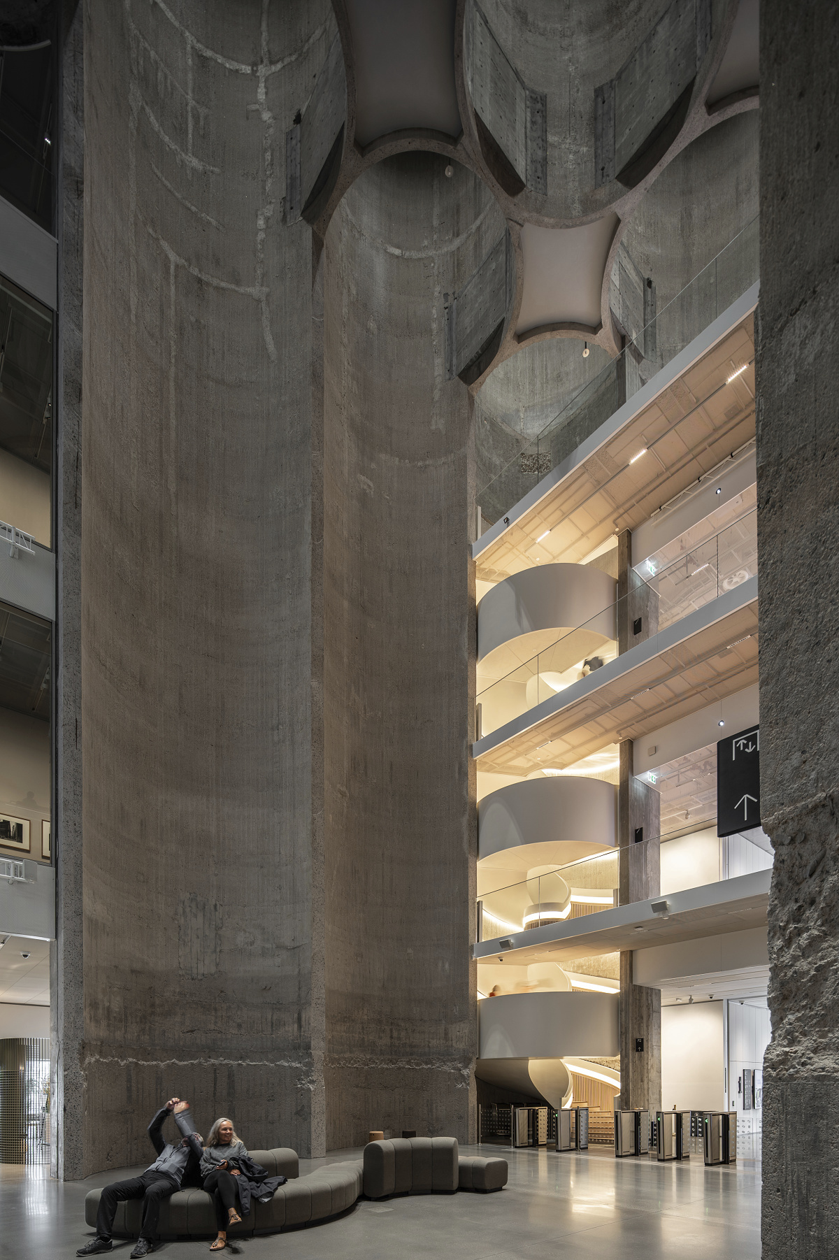 Interior of Kunstsilo Kristiansand, showcasing concrete structure and stairwell lighting.
