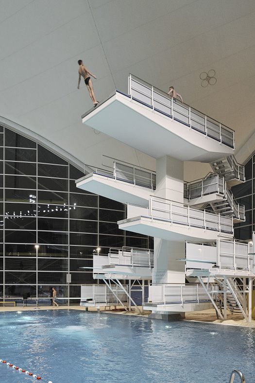 Diver on a diving platform at the Aquatic Centre, Olympic Park Munich, with ERCO LED lighting.