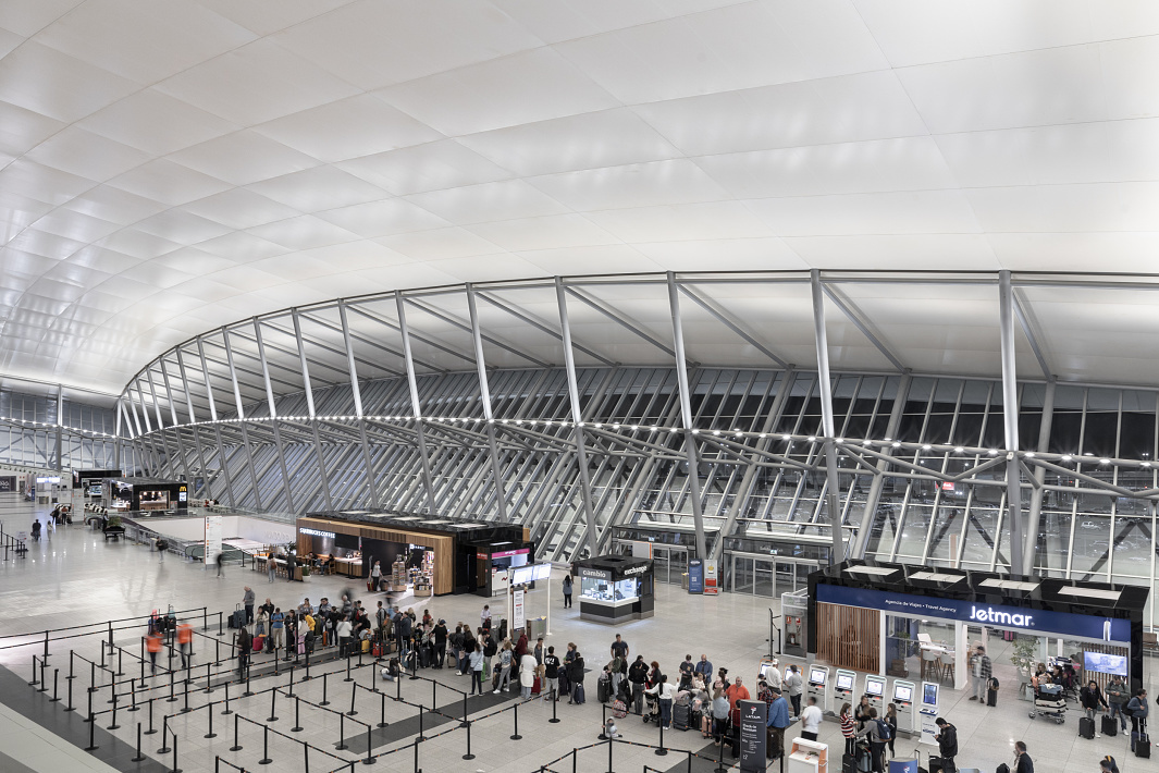 Carrasco International Airports interior featuring LED lighting and travelers waiting.