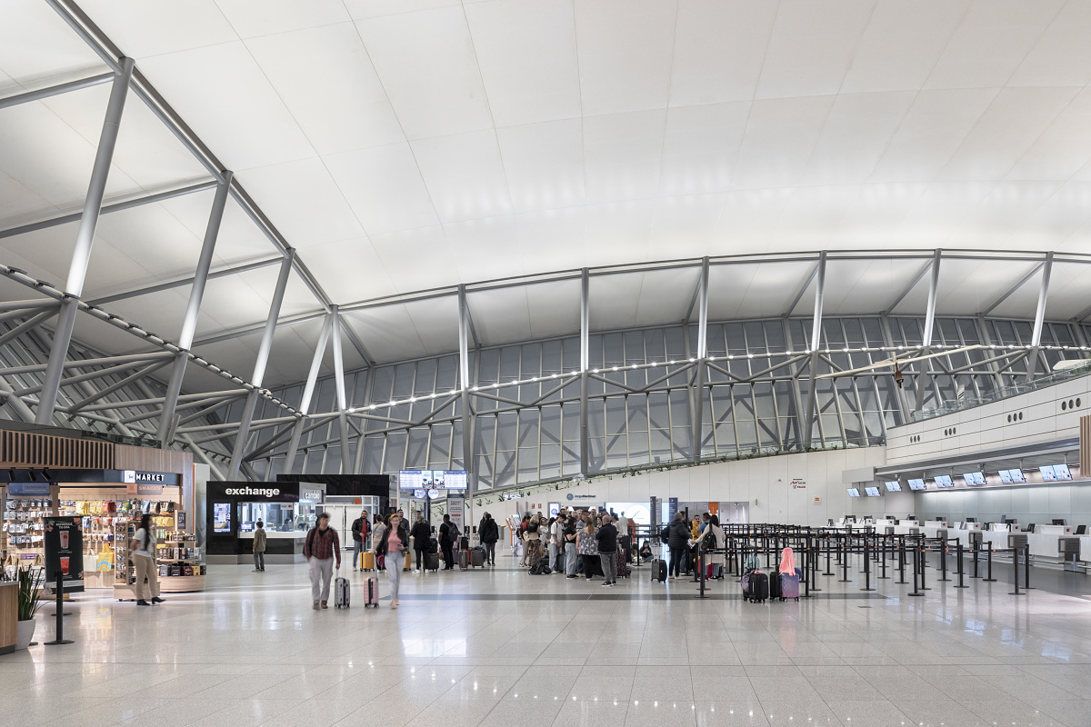 Carrasco Airport terminal featuring ERCO LED lighting and passengers.