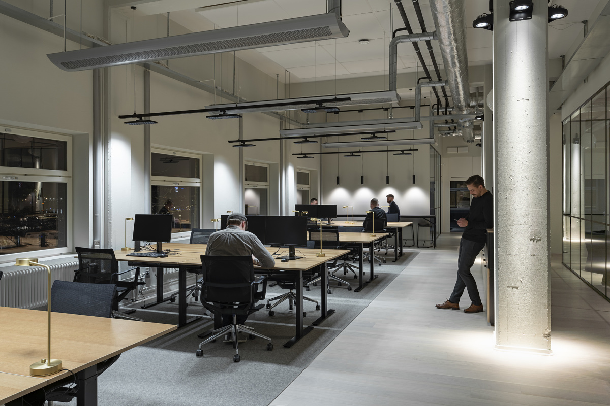ERCO track system lighting with Jilly downlights providing flexible illumination in a modern office.