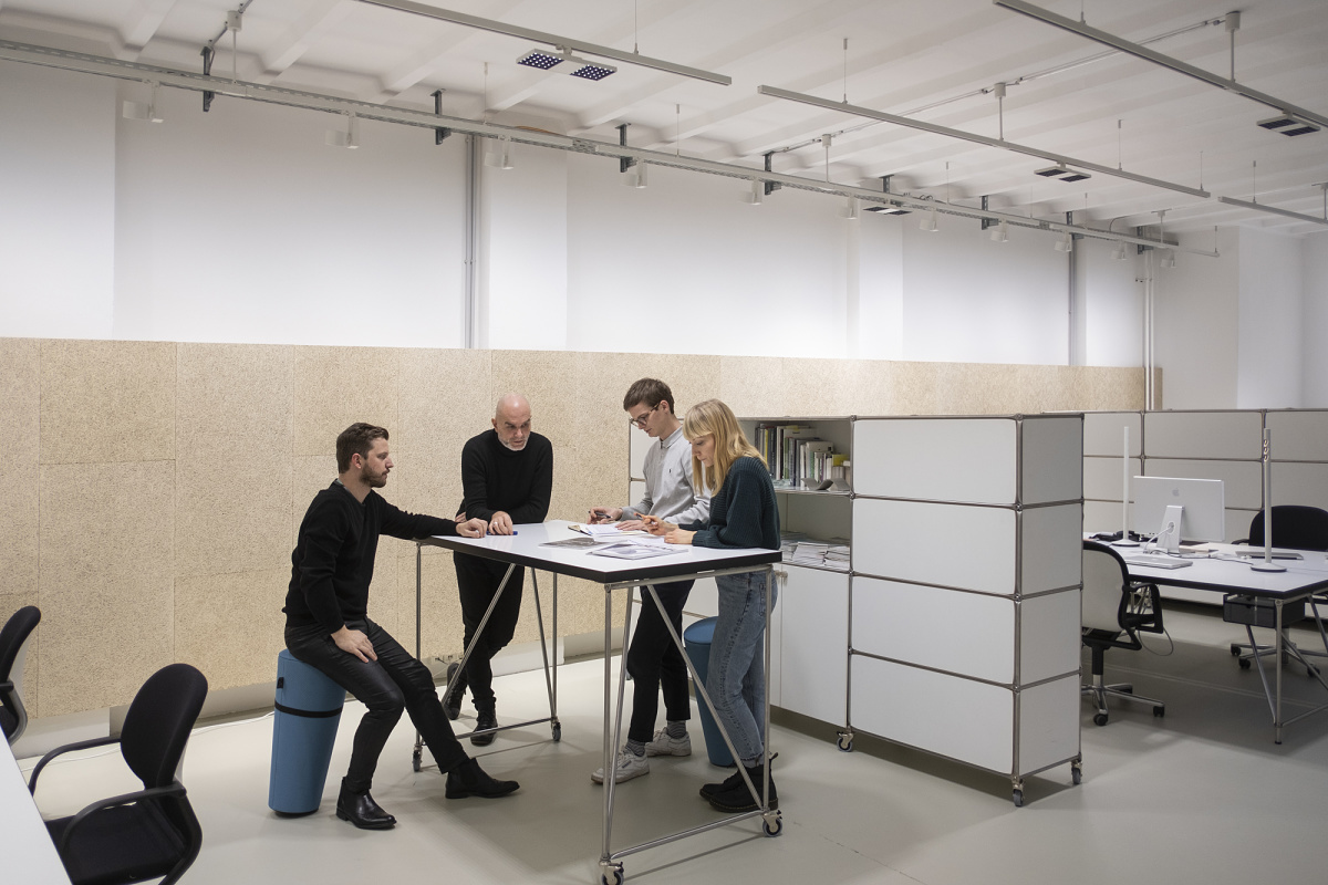 Flexible office lighting with ERCO track-mounted spotlights for modern workspaces.