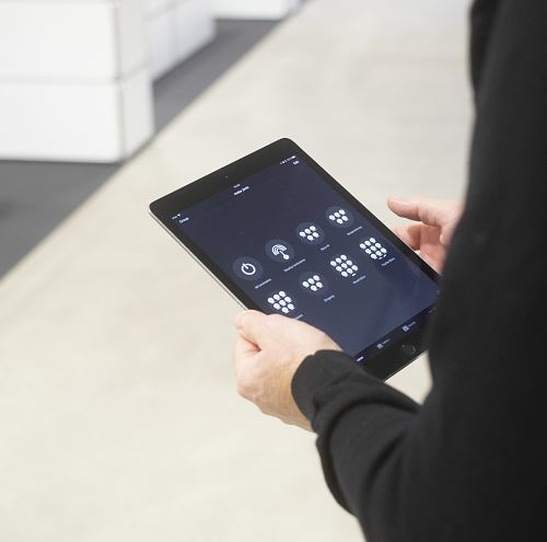 Tablet controlling ERCO track lighting for flexible office spaces.