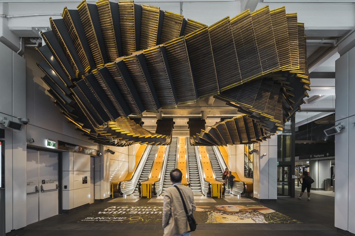 Decorative ceiling installation with ERCO lighting in a train station.