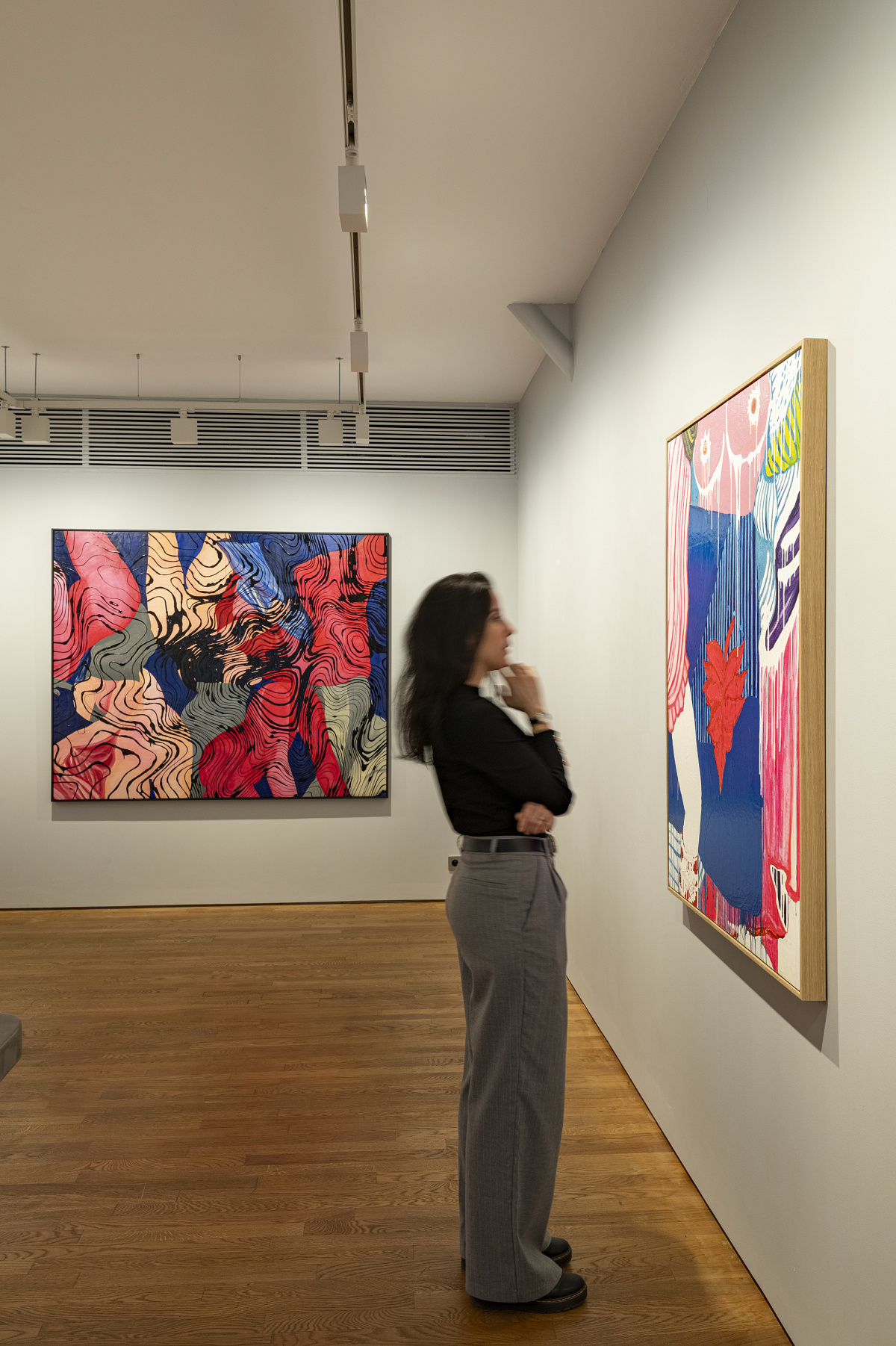 Woman viewing art at Lilia Ben Salah Gallery, illuminated by ERCO LED spotlights.