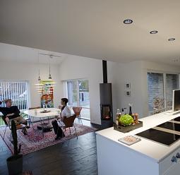 ERCO recessed ceiling lights illuminate a bright living space with people at a table.