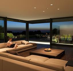 ERCO residential lighting: Woman reading on sofa, accent lighting creates a cozy atmosphere.