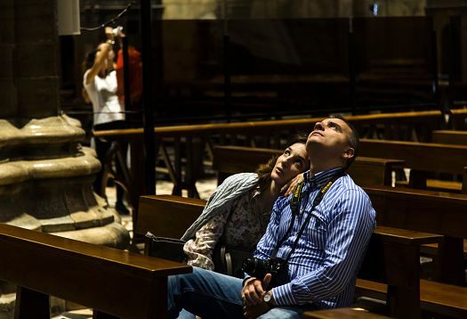 Visitors admire the LED lighting in Milan Cathedral, highlighting its Gothic architecture.