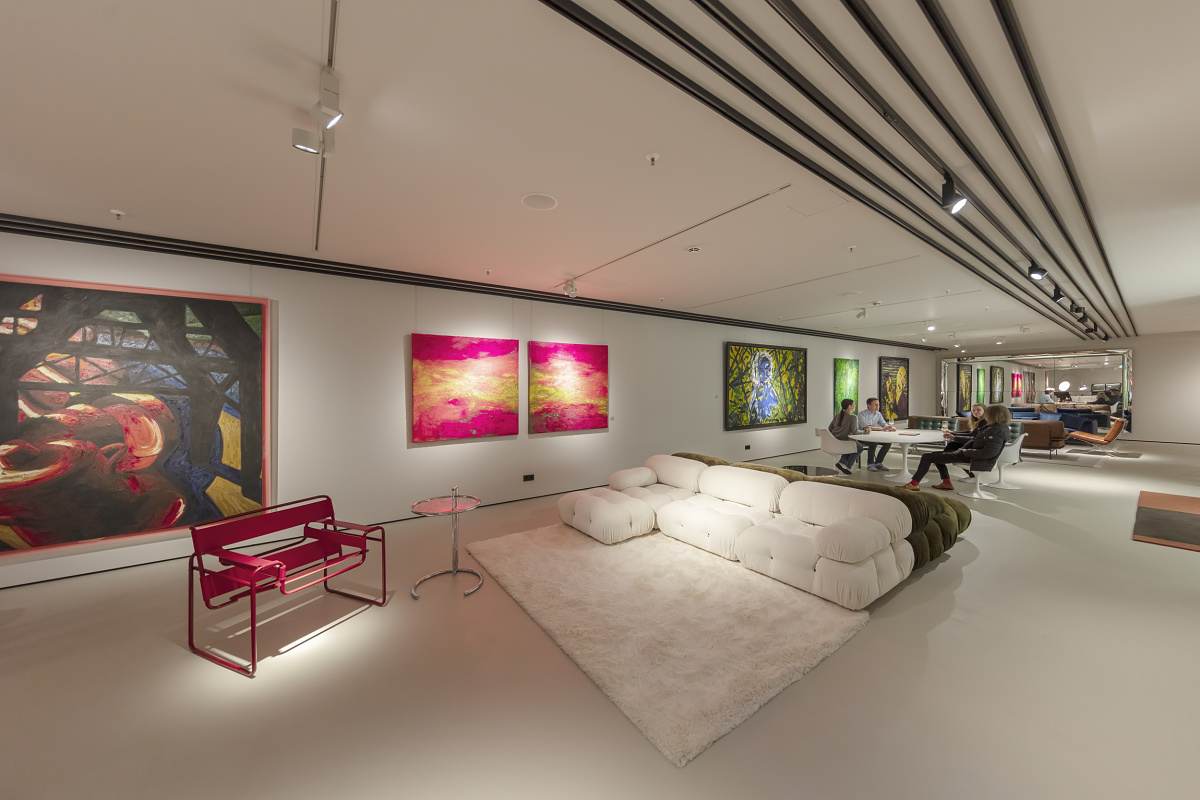Minotti flagship store interior featuring ERCO lighting, highlighting art and furniture.