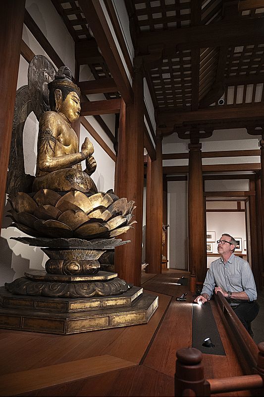 Illuminated Buddha statue at the Museum of Fine Arts, Boston, using ERCO LED lighting.