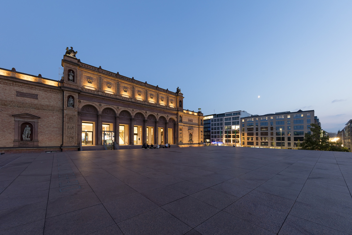 Illuminated facade of the Alte Nationalgalerie museum in Berlin at night.