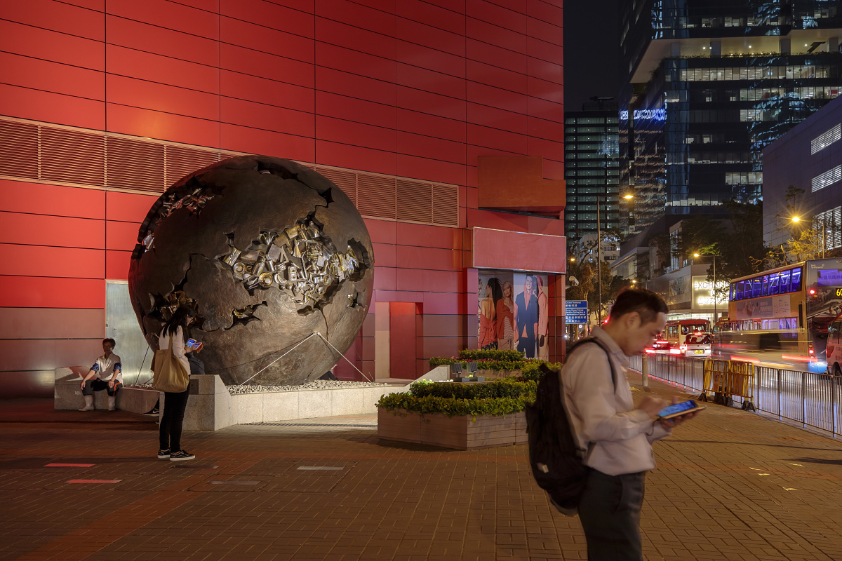Illuminated sphere sculpture outside a museum, creating cultural experiences with light.