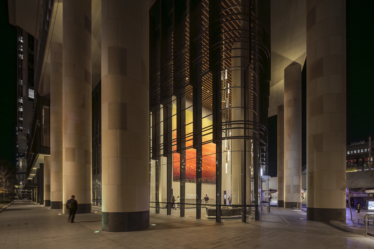 Parramatta Square at night: Illuminated columns and facade create an inviting atmosphere.