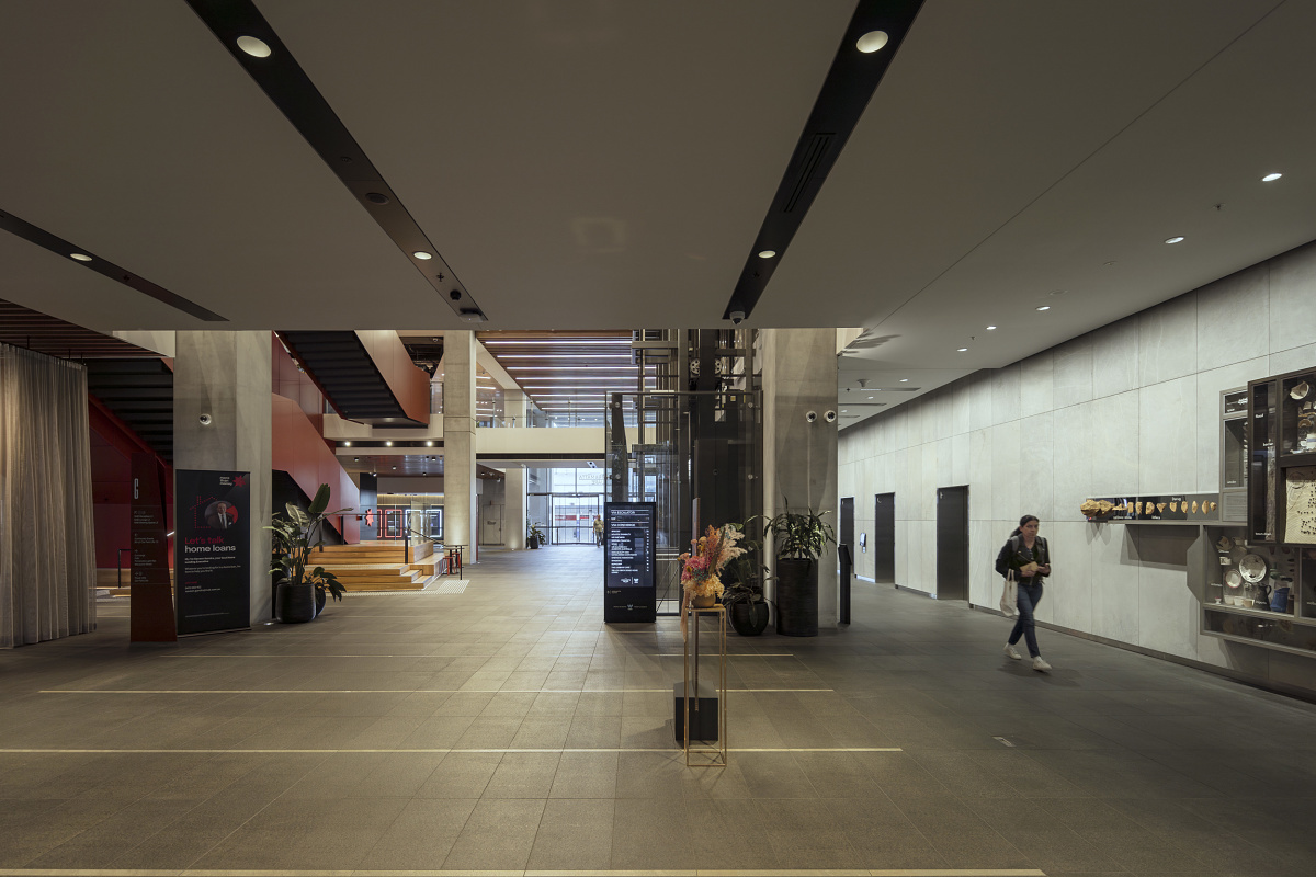Parramatta Square lobby interior featuring ERCO lighting, highlighting architectural details and guiding visitors.